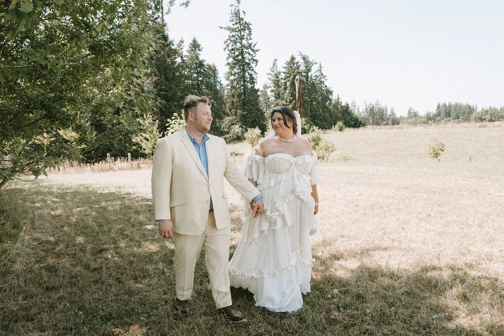 Ethan and Natasha on their wedding day, Natasha wearing her custom wedding dress by Madison Chamberlain